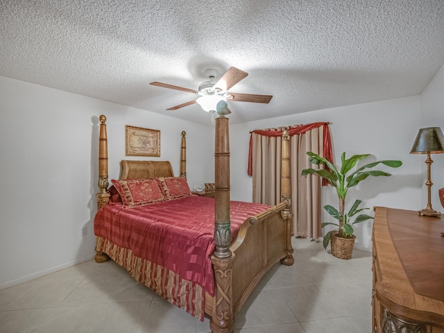 bedroom with ceiling fan and a textured ceiling