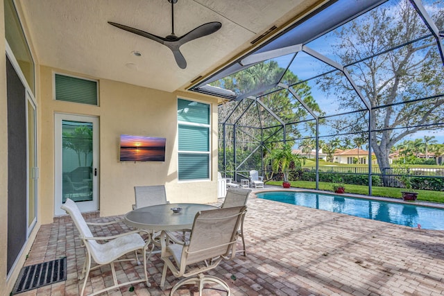 view of pool featuring ceiling fan, a lanai, and a patio area