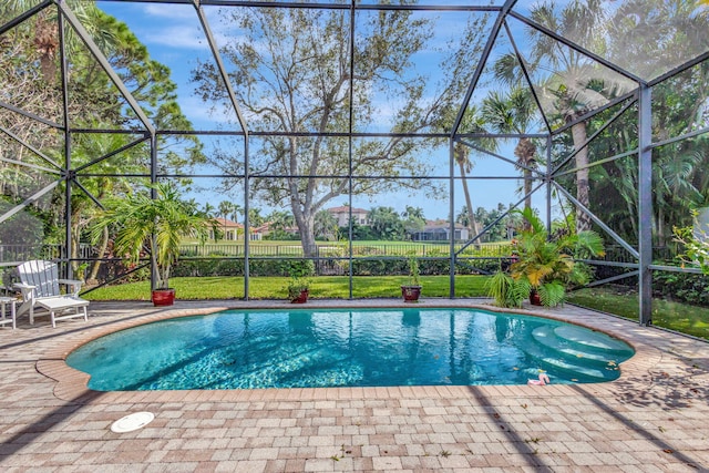 view of swimming pool with a patio and glass enclosure