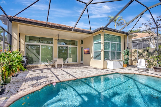 back of house with a lanai, ceiling fan, and a patio area