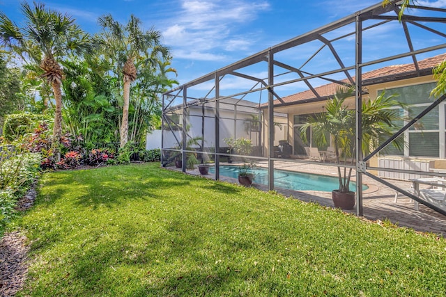 view of swimming pool with glass enclosure and a lawn