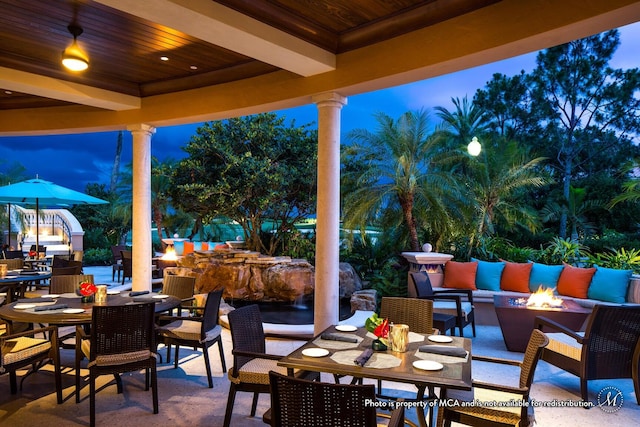 patio terrace at dusk featuring outdoor lounge area