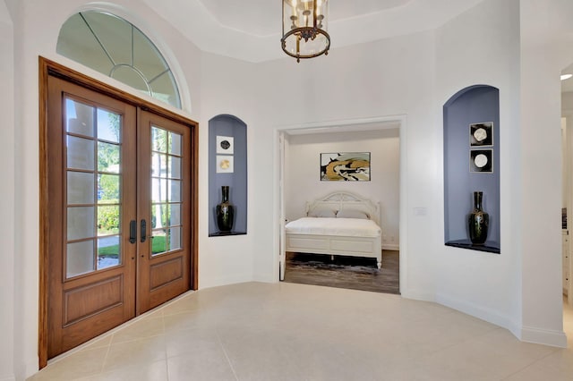 foyer featuring french doors and tile patterned flooring