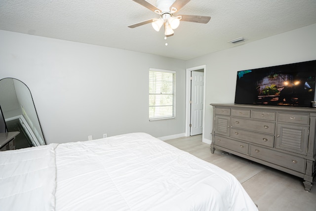 bedroom featuring a textured ceiling and ceiling fan