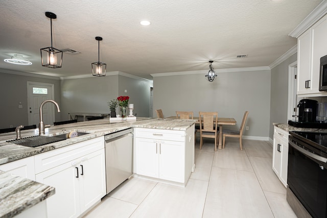 kitchen featuring appliances with stainless steel finishes, decorative light fixtures, and white cabinets