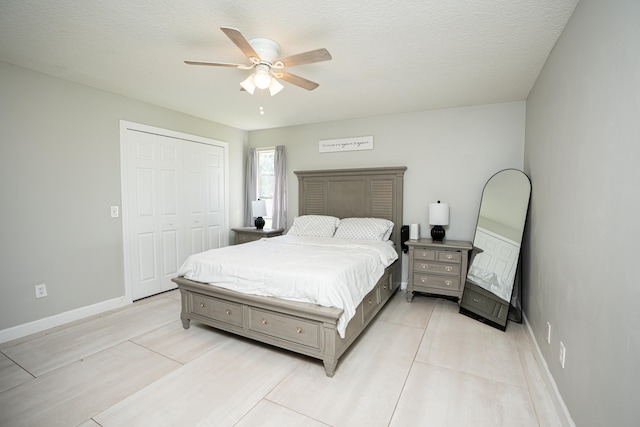 tiled bedroom with a textured ceiling, a closet, and ceiling fan