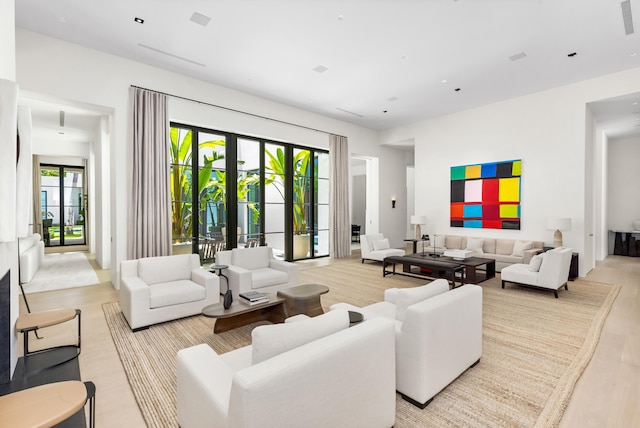 living room with french doors and light wood-type flooring