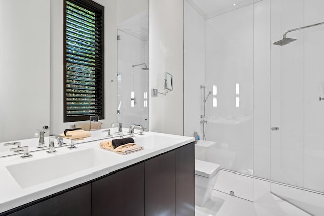 bathroom with vanity, toilet, a wealth of natural light, and tiled shower