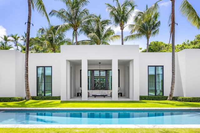 back of property featuring a yard and an outdoor living space