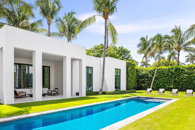 view of pool featuring a patio and a lawn