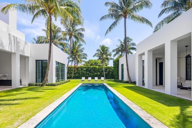 view of pool with a yard and a patio area