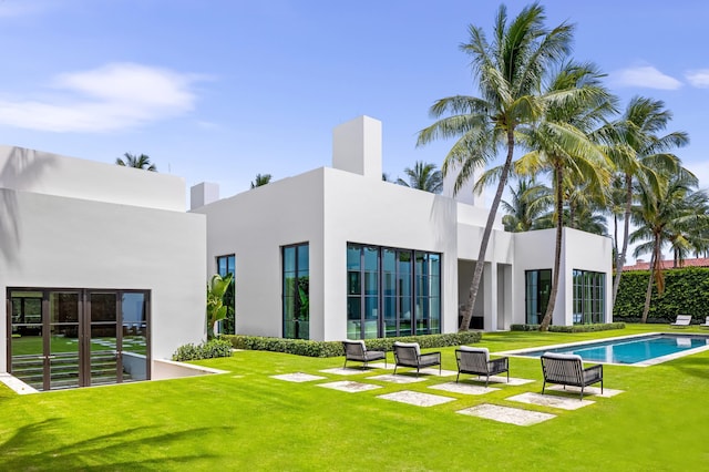 rear view of house featuring a patio area and a yard