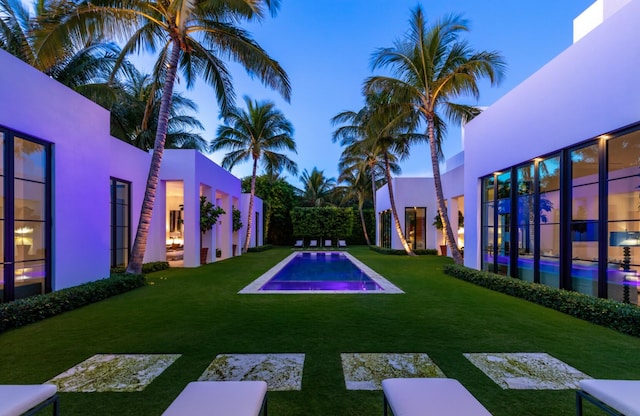 pool at dusk with a yard