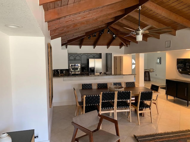 dining area featuring vaulted ceiling with beams, ceiling fan, wooden ceiling, and light tile patterned floors