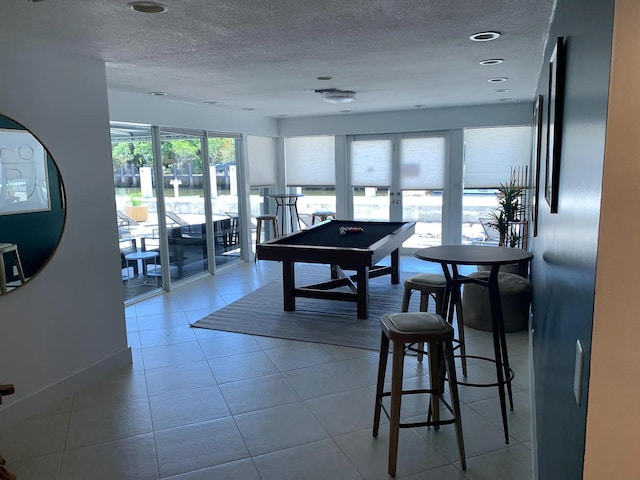 playroom featuring tile patterned flooring, a textured ceiling, and pool table