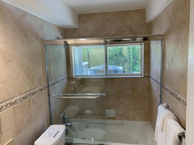 bathroom featuring toilet and enclosed tub / shower combo