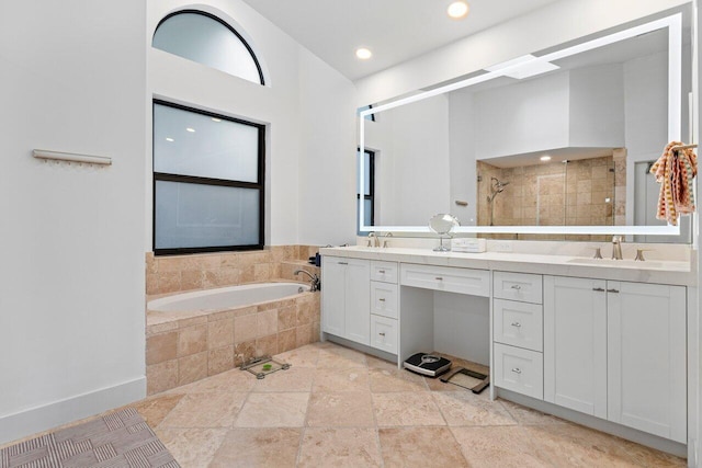 bathroom featuring vanity and shower with separate bathtub