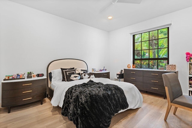 bedroom with light hardwood / wood-style floors and ceiling fan