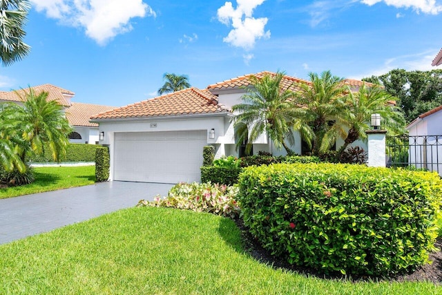 mediterranean / spanish house with a front lawn and a garage