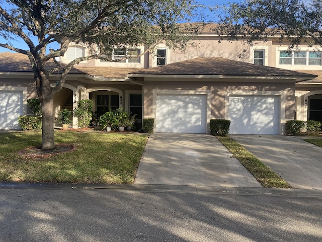 view of front of house featuring a garage and a front yard