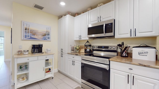 kitchen with white cabinets and appliances with stainless steel finishes