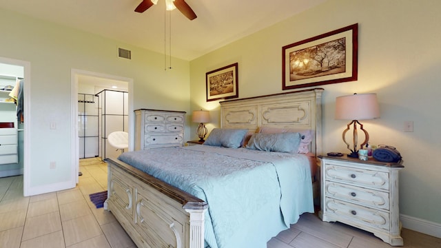 tiled bedroom featuring ensuite bathroom and ceiling fan