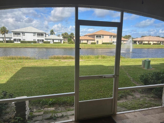 doorway to outside featuring a water view and a healthy amount of sunlight