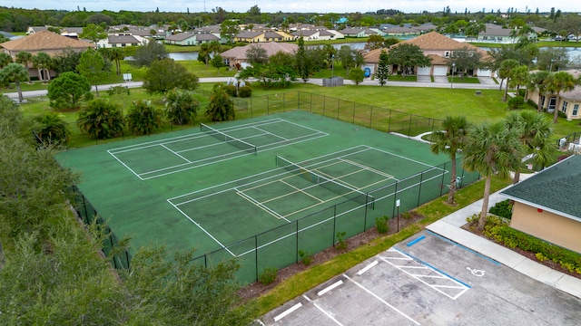 view of sport court with a yard