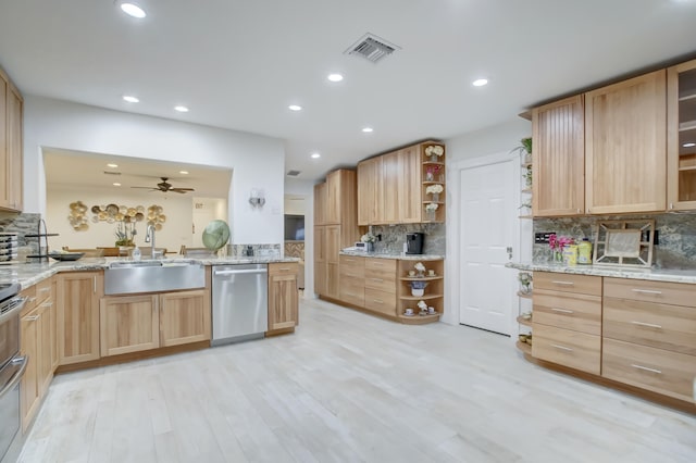 kitchen with sink, light hardwood / wood-style flooring, decorative backsplash, light brown cabinetry, and appliances with stainless steel finishes