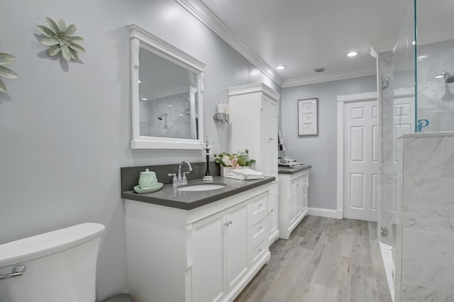 bathroom featuring an enclosed shower, ornamental molding, vanity, hardwood / wood-style floors, and toilet