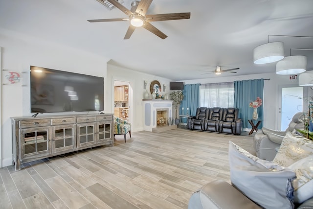 living room with ceiling fan, light hardwood / wood-style floors, and ornamental molding