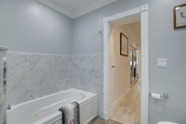 bathroom featuring a washtub, wood-type flooring, and crown molding