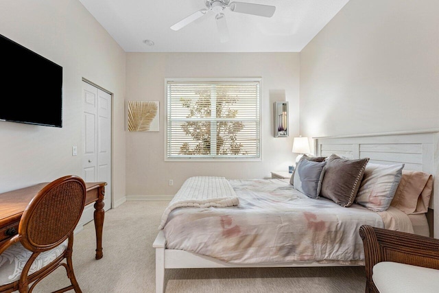 carpeted bedroom with ceiling fan and a closet