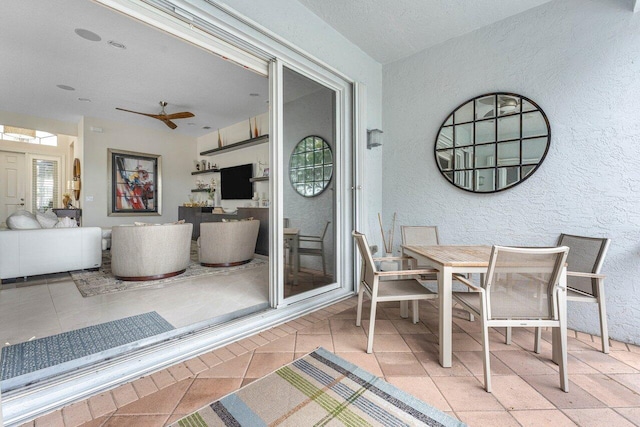 sunroom / solarium featuring ceiling fan