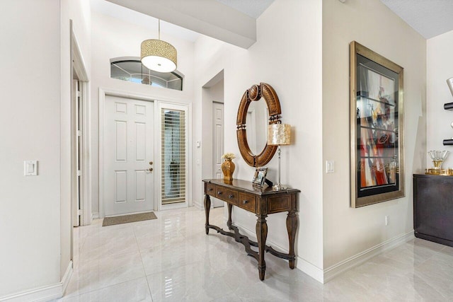 entryway featuring a textured ceiling and vaulted ceiling