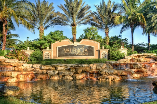 community / neighborhood sign with a water view