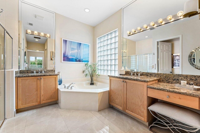 bathroom featuring a wealth of natural light, vanity, and separate shower and tub