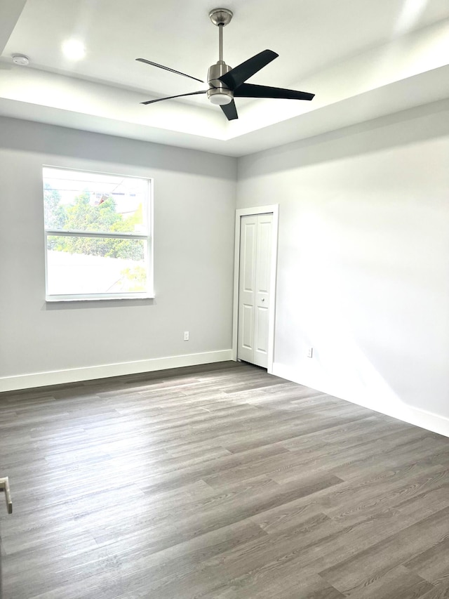 empty room featuring wood-type flooring and ceiling fan