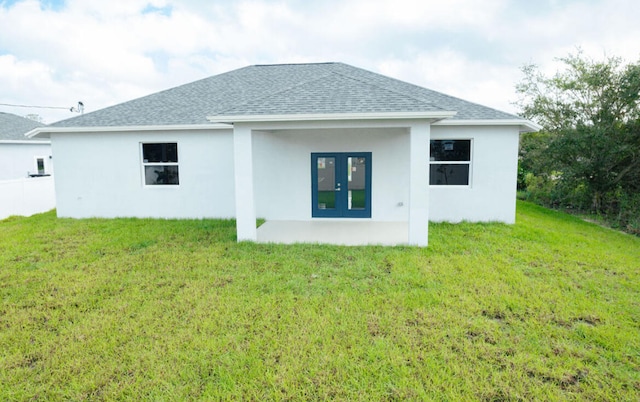 back of house with a yard and french doors