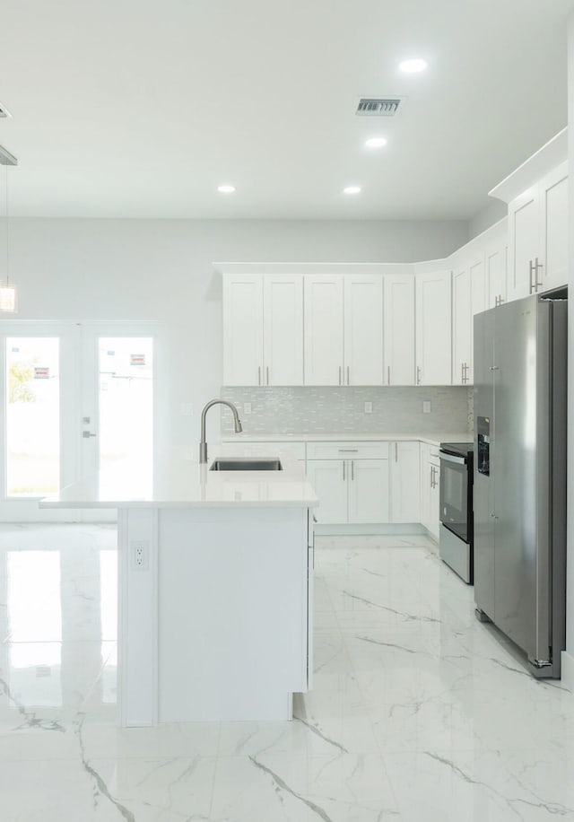 kitchen with decorative backsplash, appliances with stainless steel finishes, sink, and white cabinets