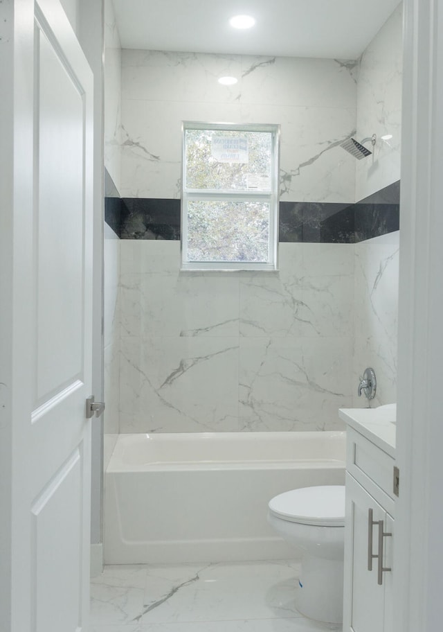 full bathroom featuring vanity, toilet, and tiled shower / bath