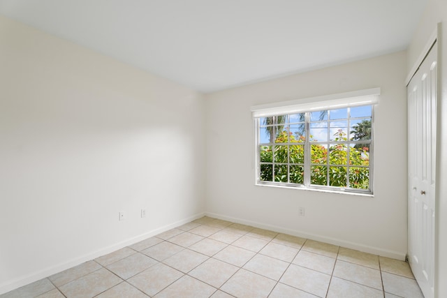 unfurnished room with light tile patterned floors