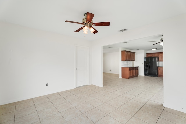 unfurnished living room featuring light tile patterned flooring and ceiling fan