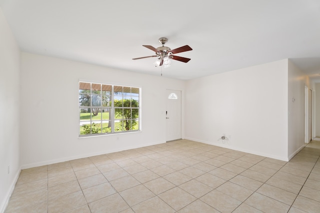 2222 SE Carnation Rd, Port Saint Lucie, FL 34952 - unfurnished room featuring a ceiling fan, light tile patterned flooring, and baseboards