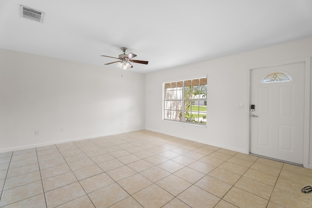 tiled foyer featuring ceiling fan