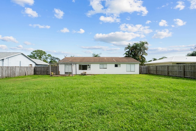 back of property featuring a yard