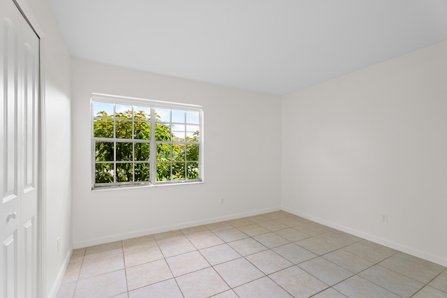 unfurnished room with light tile patterned floors