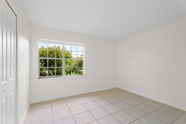 2222 SE Carnation Rd, Port Saint Lucie, FL 34952 - spare room with light tile patterned floors and baseboards