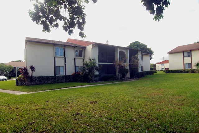 rear view of property featuring a yard