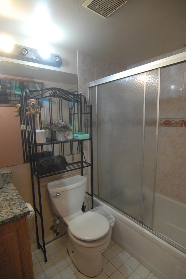 full bathroom featuring vanity, shower / bath combination with glass door, toilet, and tile patterned floors